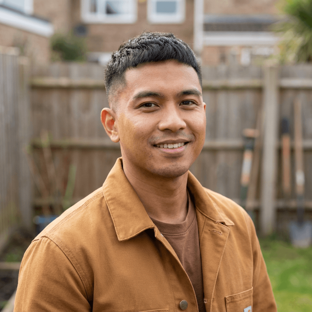 Male customer in his early 50s, Black, casual appearance by backyard patio, relaxed and content demeanor